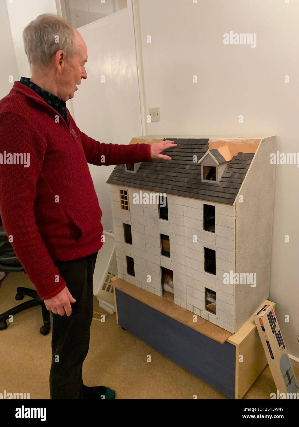 Dolls house large big working children play toy children's make made windows floor roof man looking holding make playing games game time energy - Smartphone Captured Stock Image