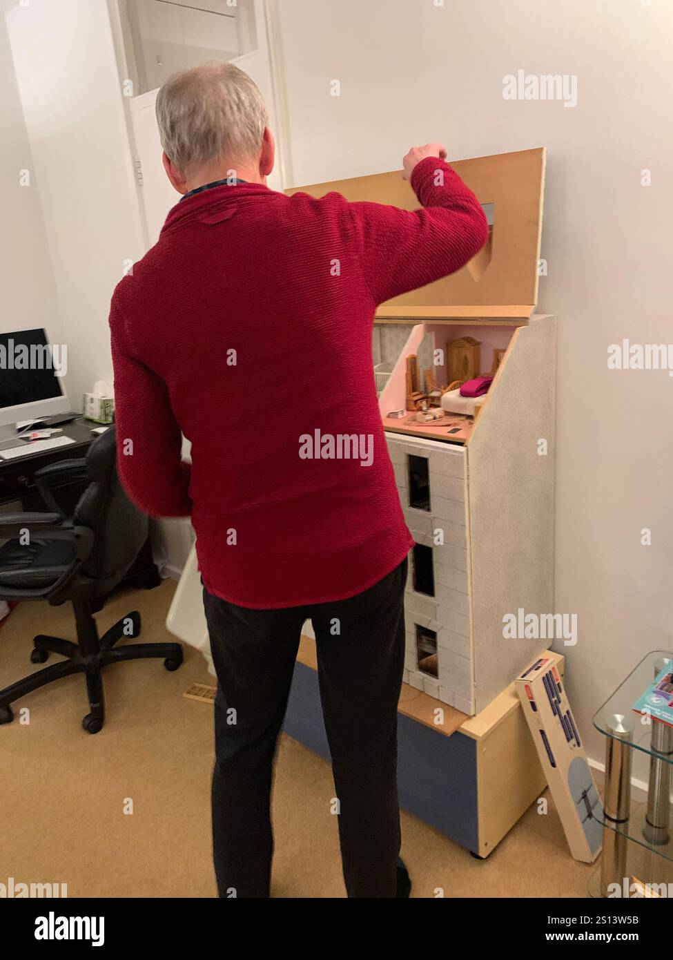 Dolls house large big working children play toy children's make made windows floor roof man looking holding make playing games game time energy - Smartphone Captured Stock Image