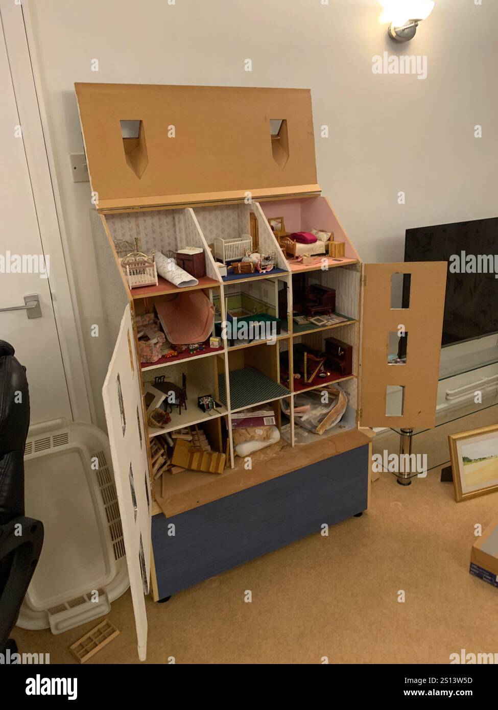 Dolls house large big working children play toy children's make made windows floor roof man looking holding make playing games game time energy - Smartphone Captured Stock Image