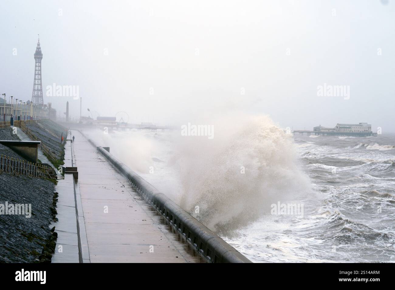 Waves break on the sea front in Blackpool, as snow, rain and wind ...