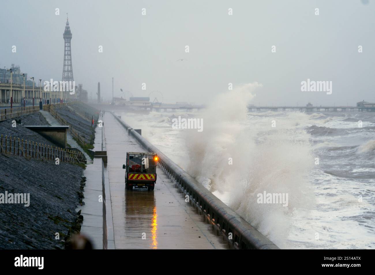 Waves break on the sea front in Blackpool, as snow, rain and wind ...