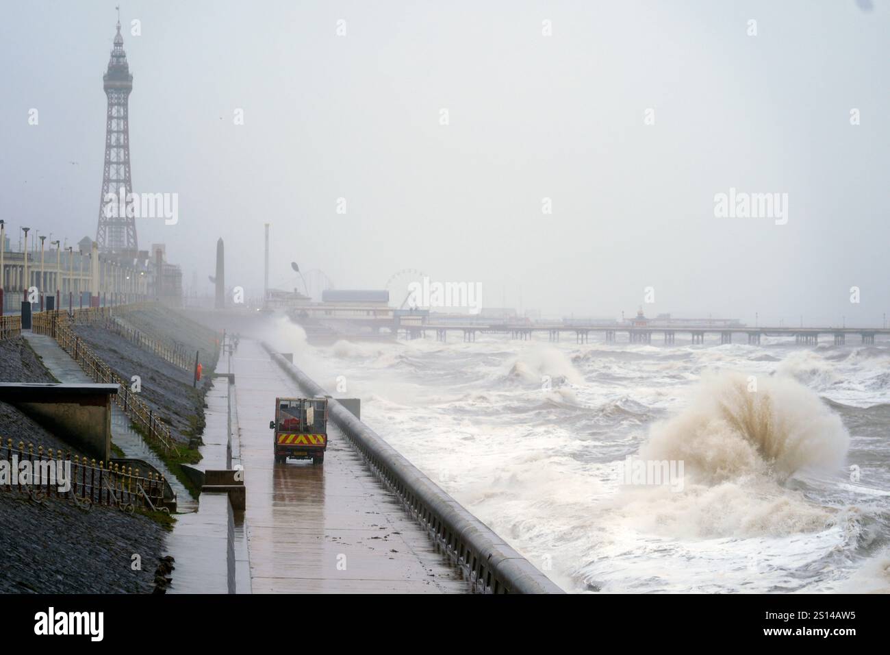 Waves break on the sea front in Blackpool, as snow, rain and wind ...