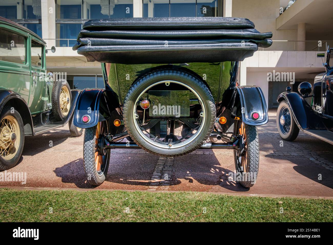 Lisbon, Portugal - Sep 29, 2024: Rear view of classic black Ford Model T Touring car known as Tin Lizzie on sunny day in urban settings. Economy car, 1920s, car of century, most sold car model, soft top, spare wheel and tyre, Ford Motor Company, USA Stock Photo