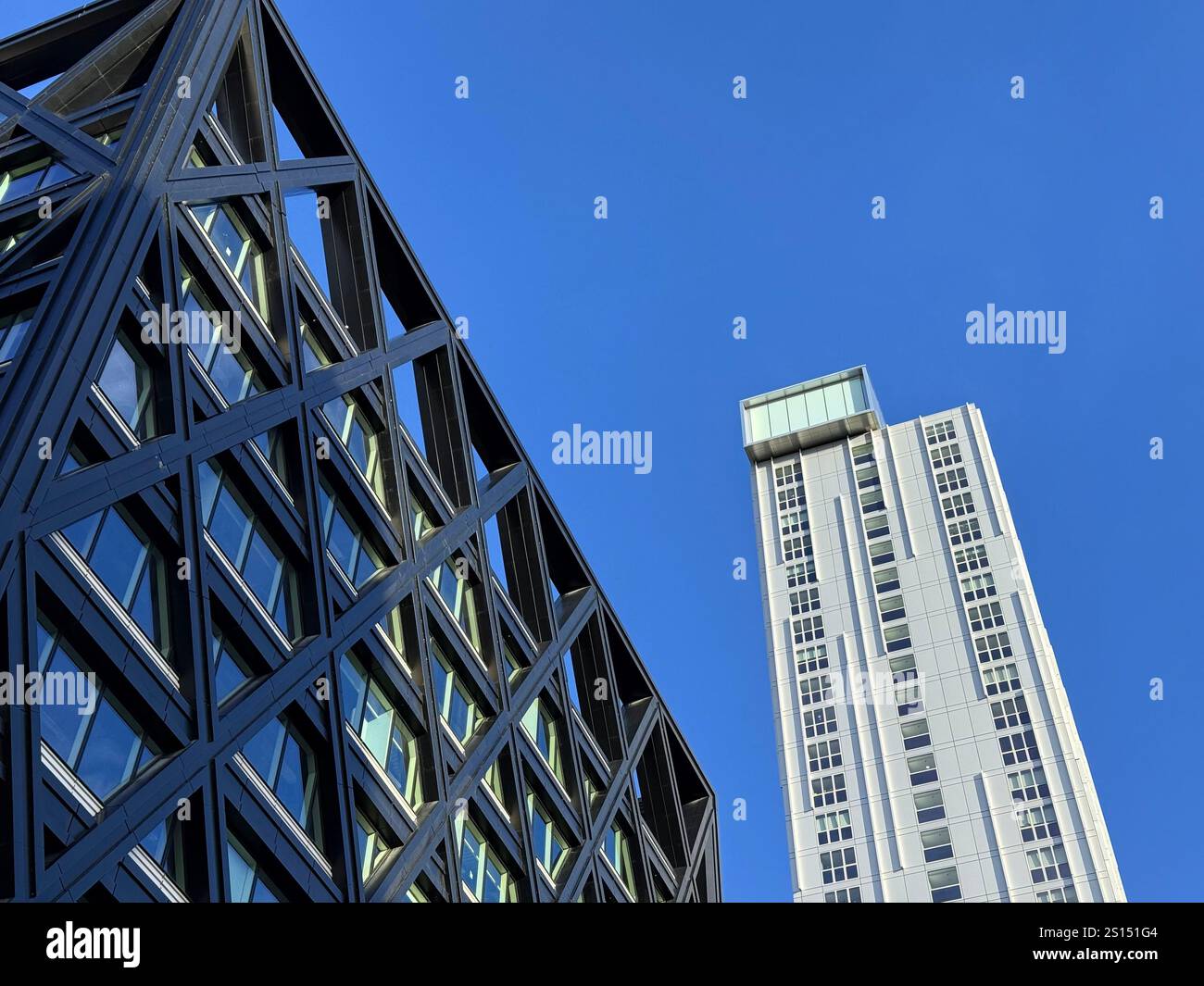 Contrasting white and black clad tower blocks in the Spinningfields discict of Manchester City Centre - Smartphone Captured Stock Image