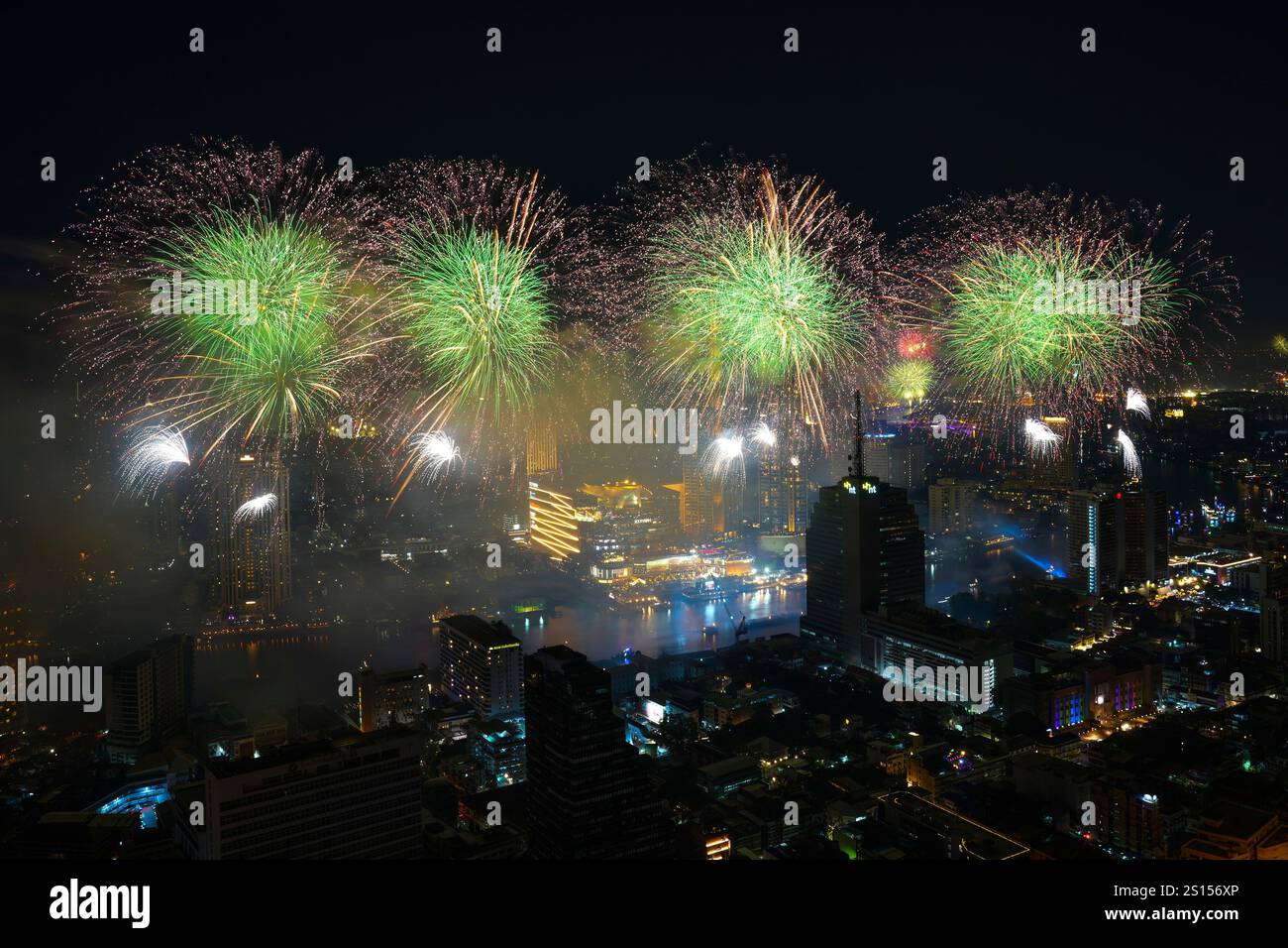 Fireworks explode over the Chao Phraya River during New Year