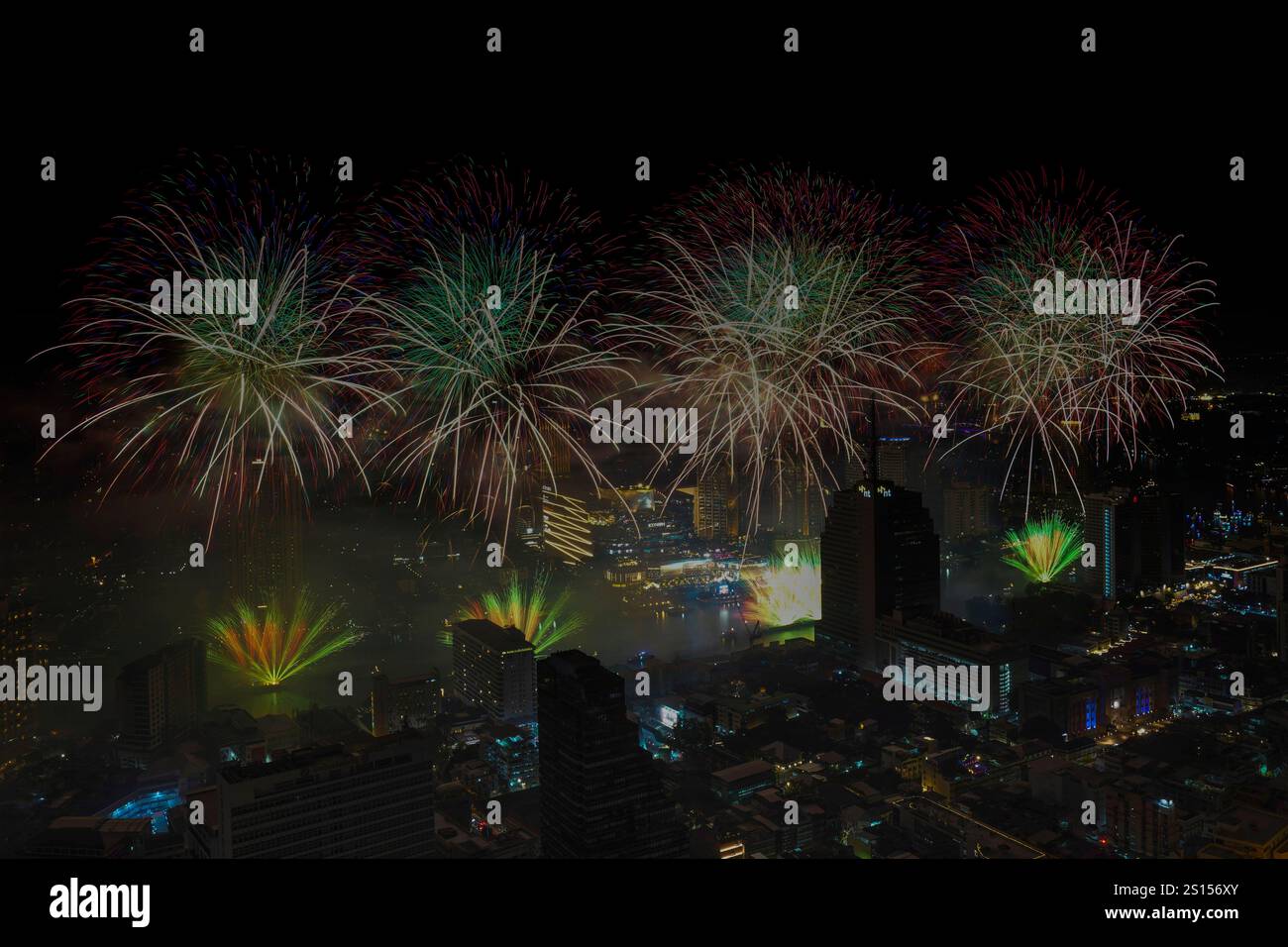Fireworks explode over the Chao Phraya River during New Year