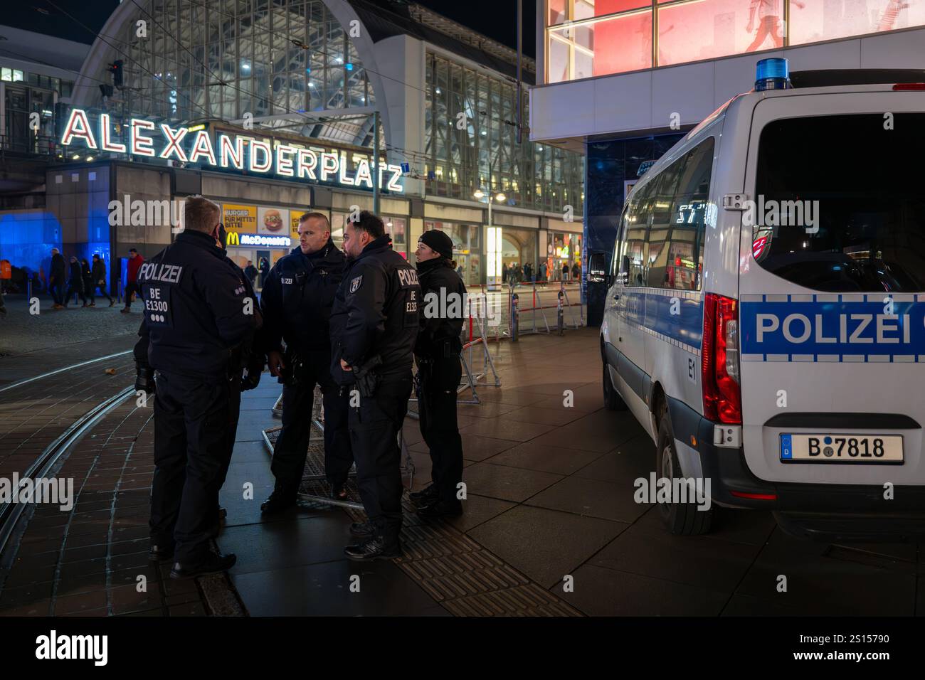 31 December 2024, Berlin: Police officers guard Alexanderplatz square