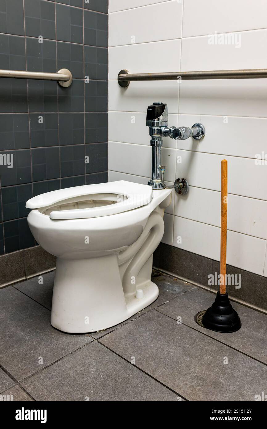 Public restroom, bathroom, toilet and plunger with handicap handrails ...