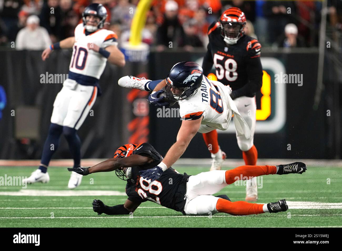 Denver Broncos tight end Adam Trautman is tackled by Cincinnati Bengals ...