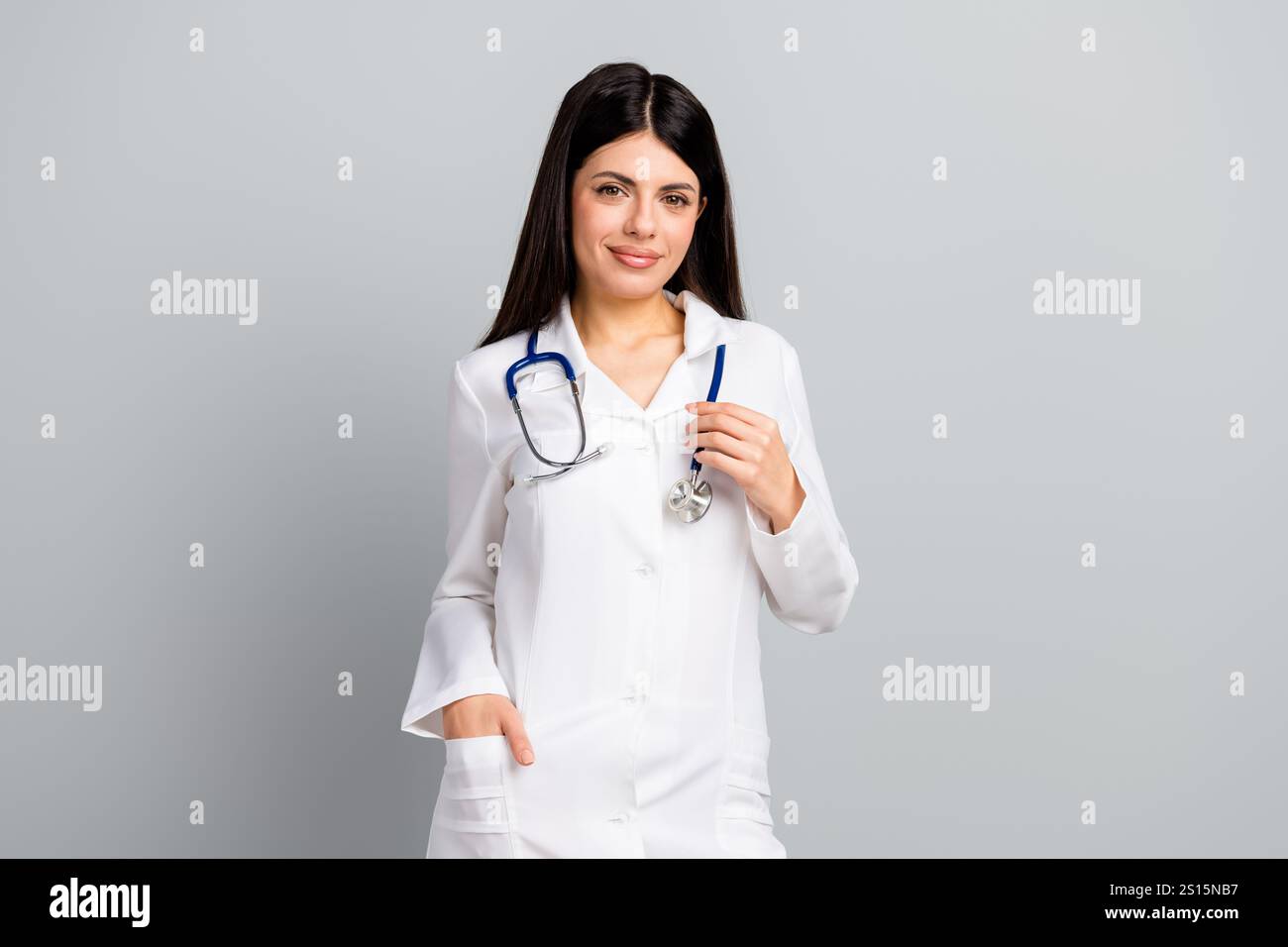 Young female doctor in white uniform with stethoscope standing ...