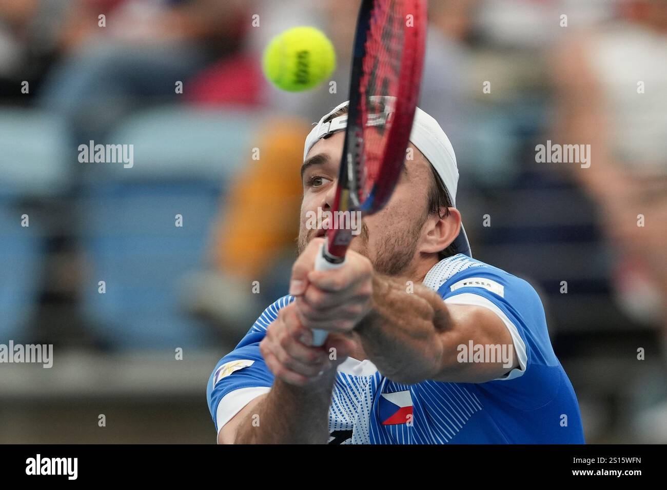 Czech Republic's Tomas Machac plays a backhand return to Poland's