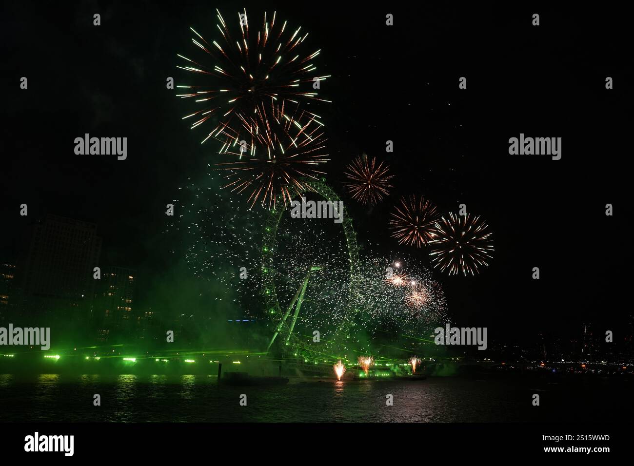Fireworks light up the sky over the London Eye in central London during