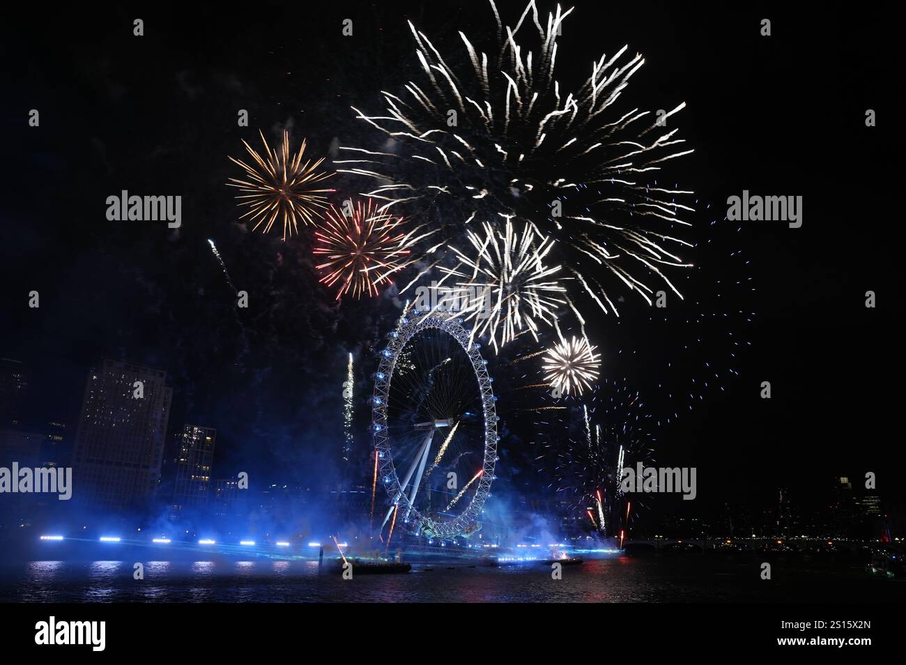 Fireworks light up the sky over the London Eye in central London during