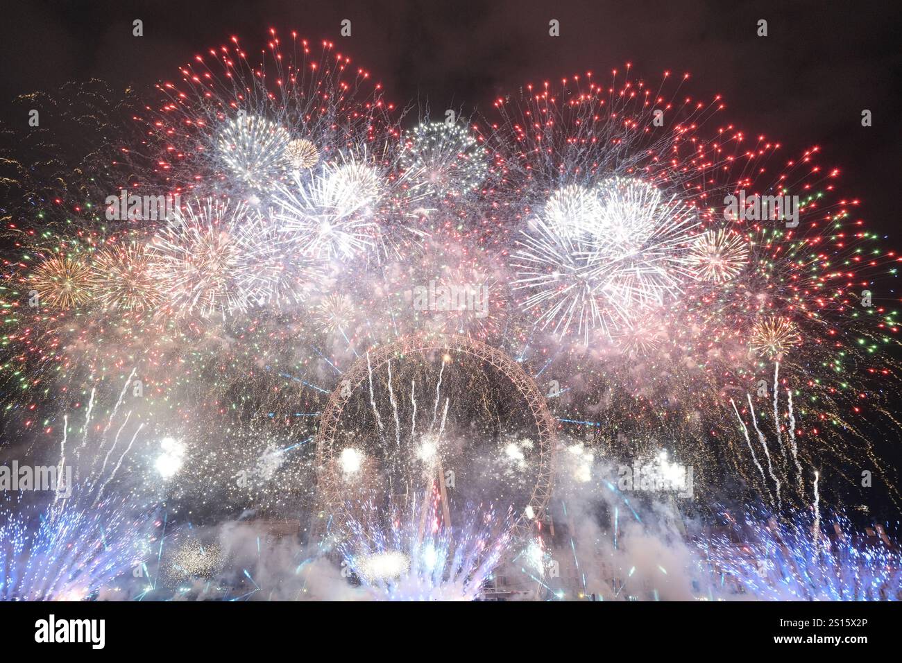 Fireworks light up the sky over the London Eye in central London during