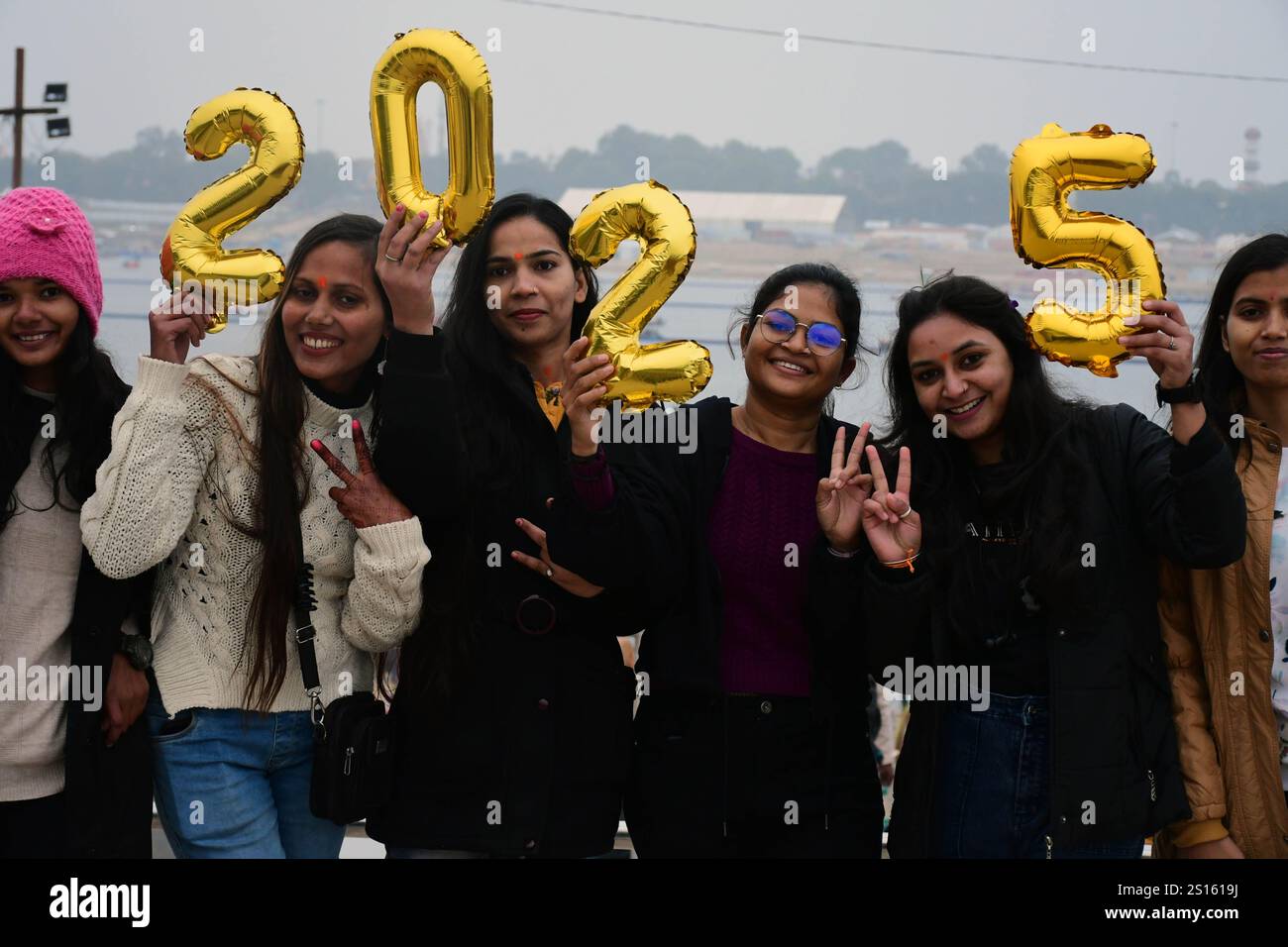 Indian youth hold balloons with numbers 2025 on the occasion of the new