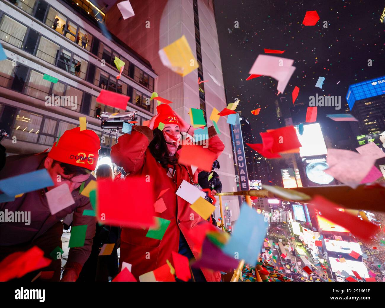 Revelers stand atop the New York Marriott Marquis in Times Square as