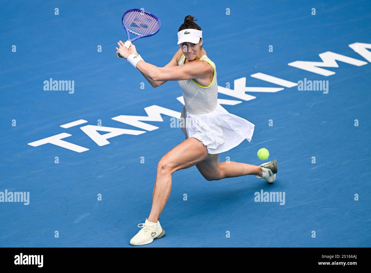Bernarda Pera of the U.S., plays a shot against Rebecca Marino of