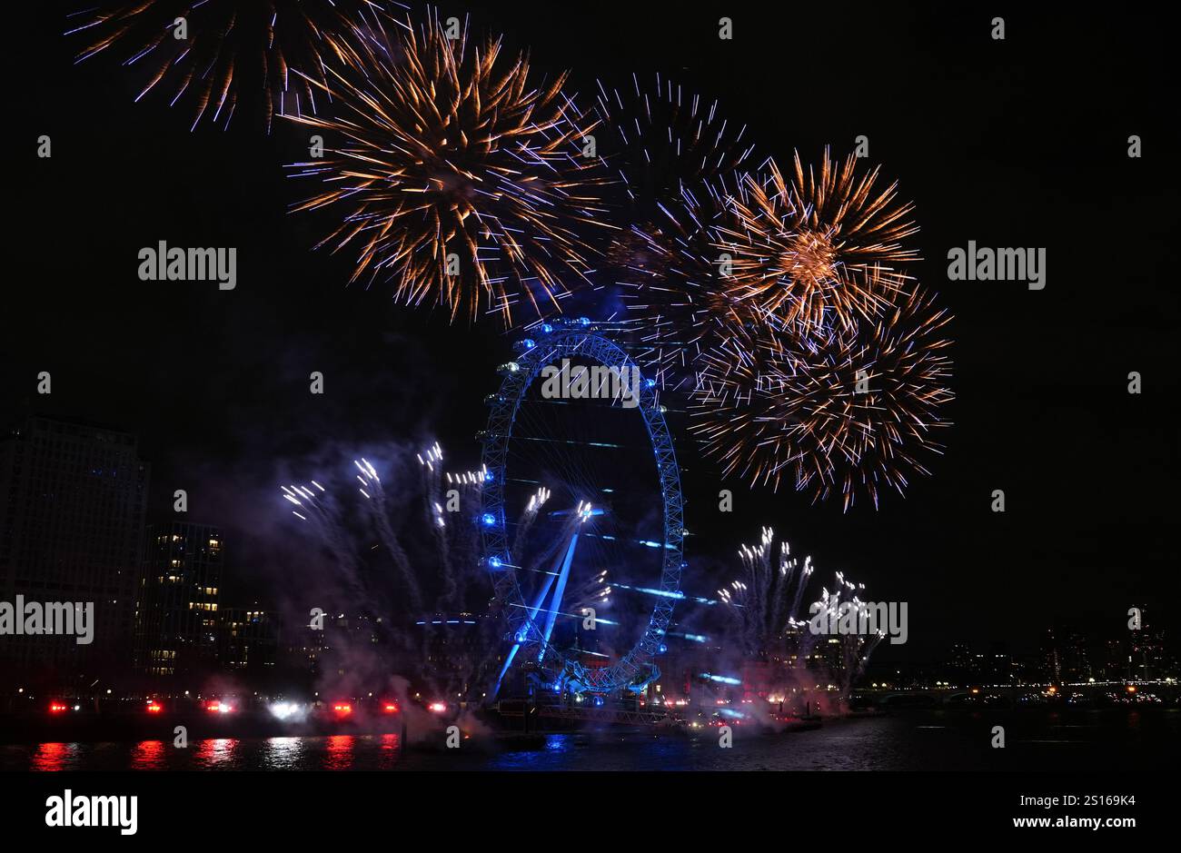 Fireworks light up the sky over the London Eye in central London during
