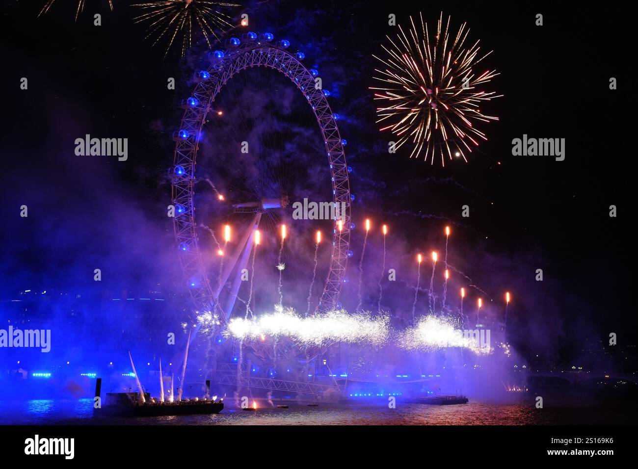 Fireworks light up the sky over the London Eye in central London during