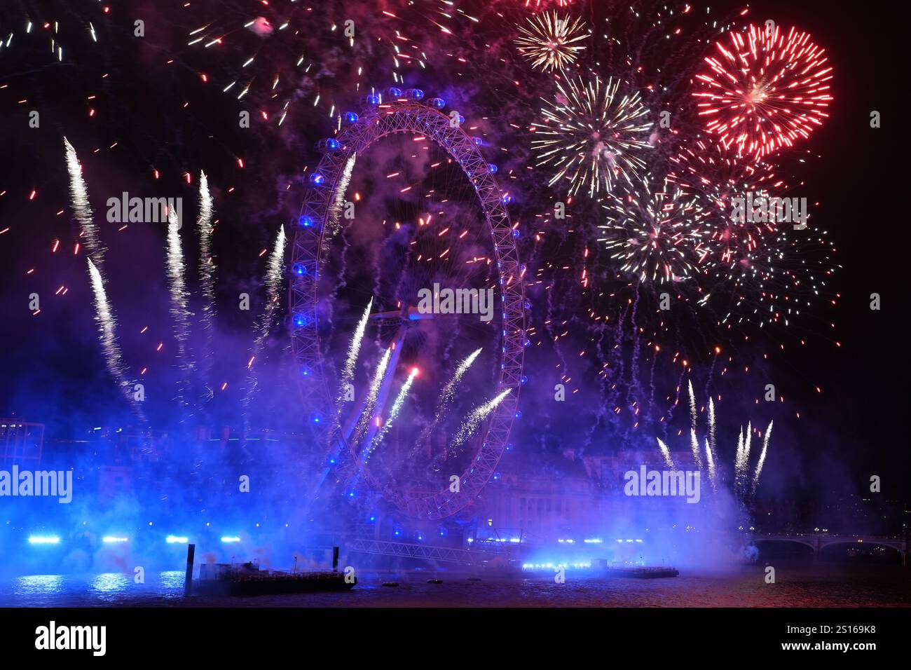 Fireworks light up the sky over the London Eye in central London during