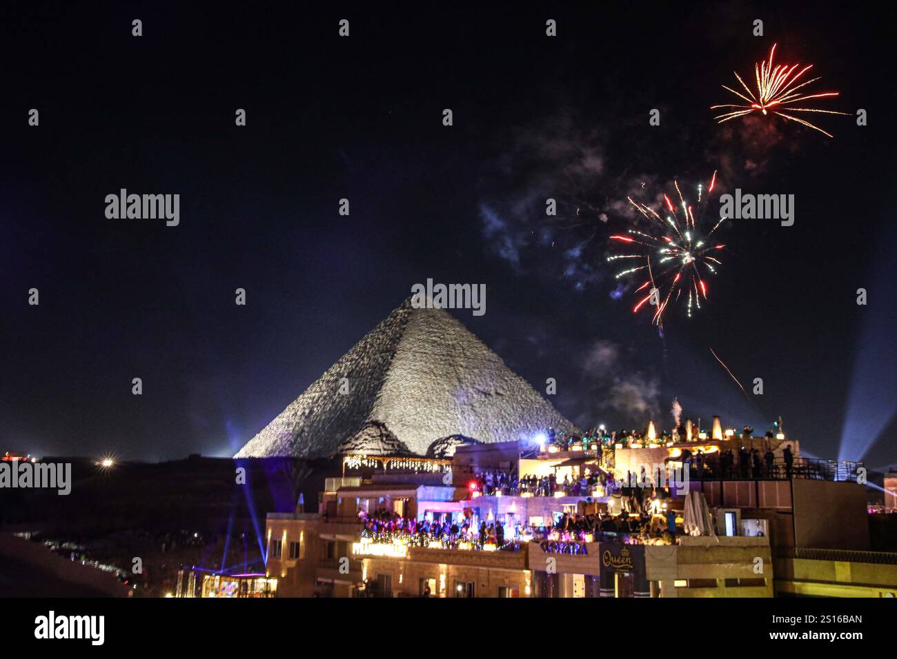 Giza, Egypt. 31st Dec, 2024. Fireworks explode over the Giza Pyramids ...