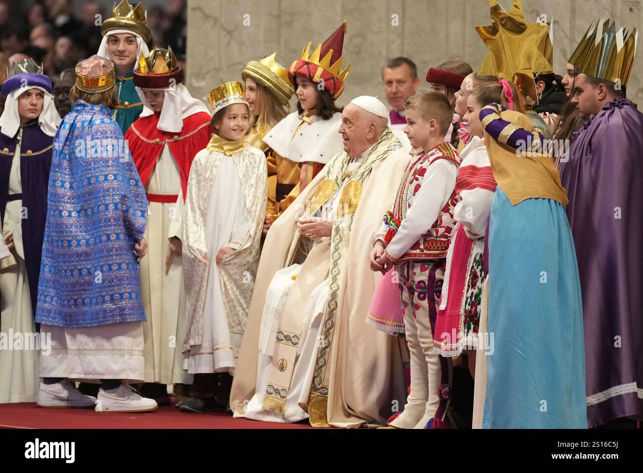 Pope Francis is joined by children dressed with costumes inspired by