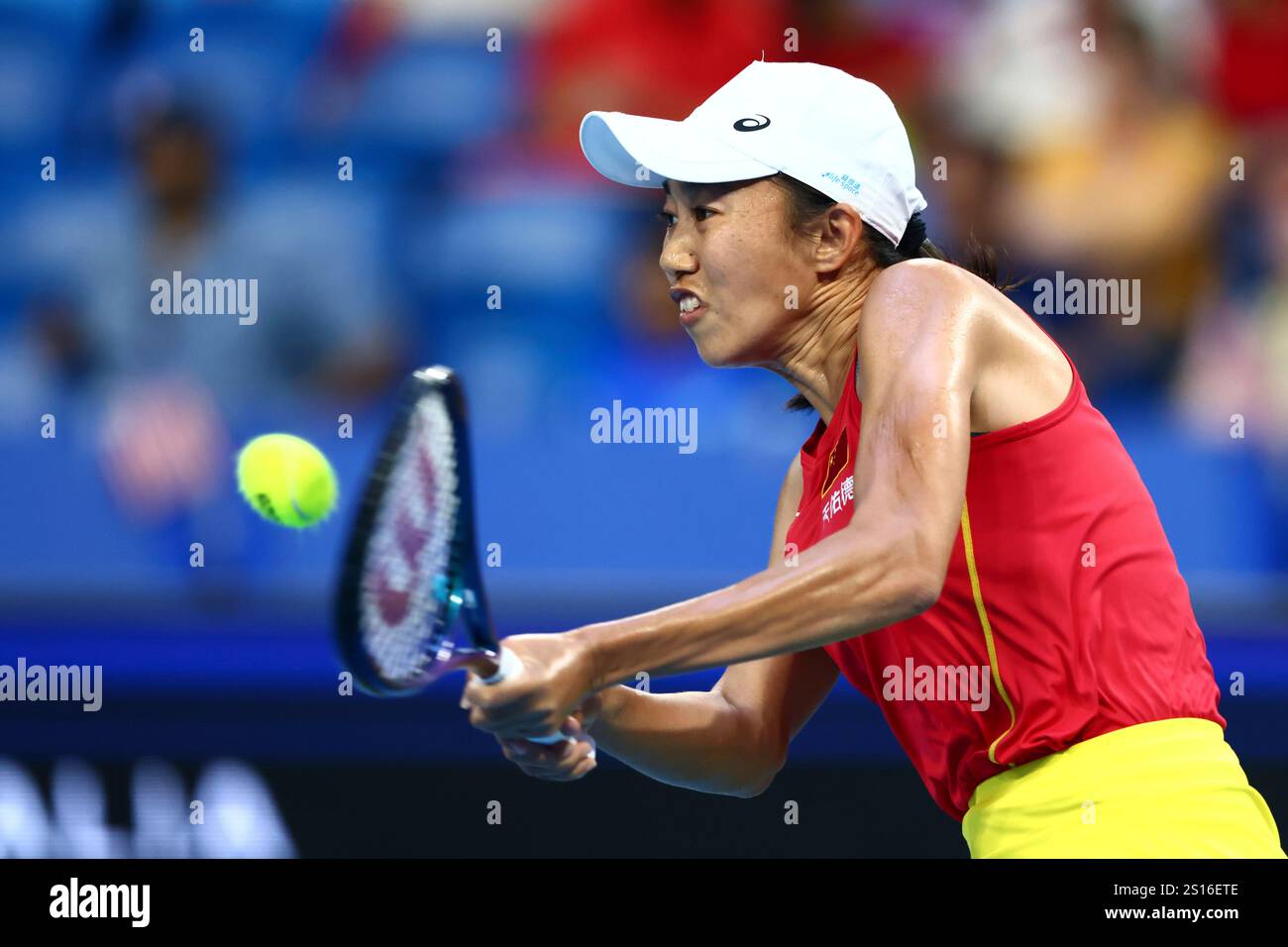 Shuai Zhang of China hits a return shot to Coco Gauff of the United