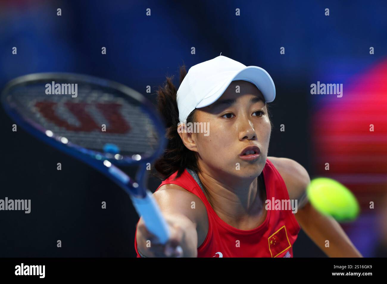 Shuai Zhang of China hits a return shot to Coco Gauff of the United
