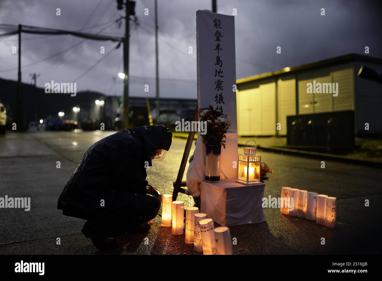 Candles are lit in front of temporary housing in Wajima, Ishikawa