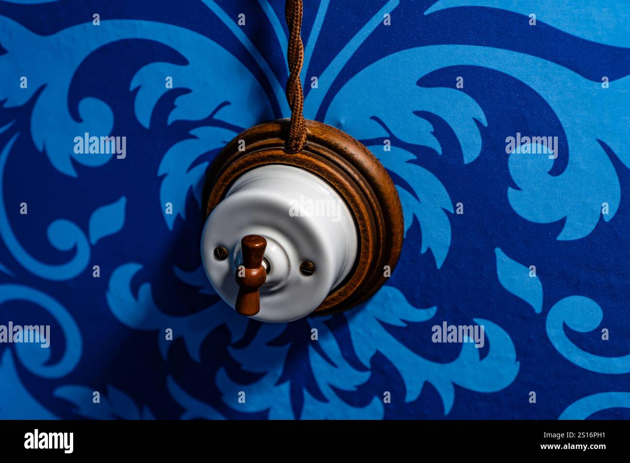 old switch lever on blue background Stock Photo