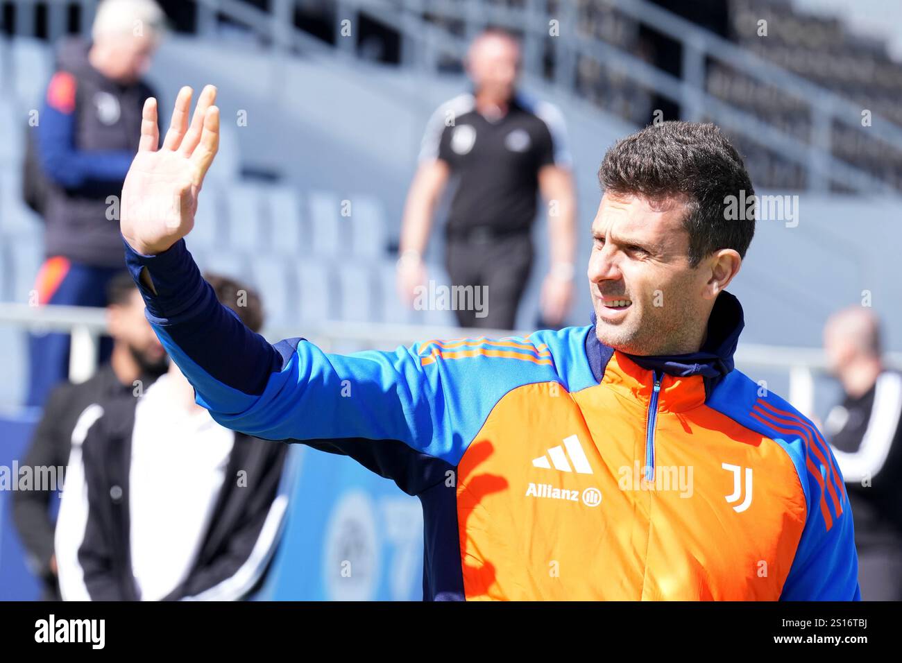 Juventus’ head coach Thiago Motta sign autographs as they enter the