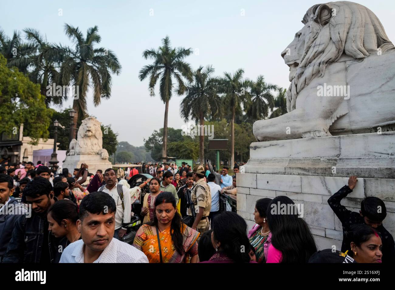 People gather around the entrance of Victoria Memorial garden as they