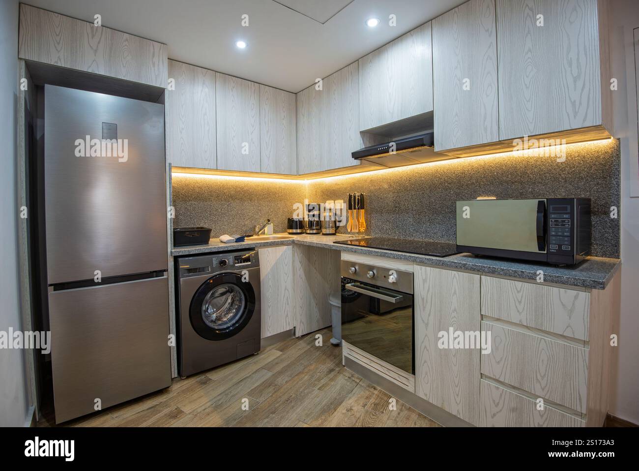 View of Kitchen area in luxury apartment show home showing open plan interior ...
