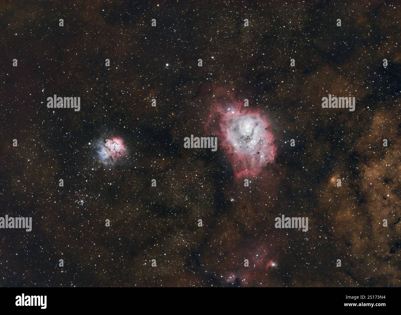image of the trifid nebula (right), and the lagoon nebula (left) over the backdrop of the milky way Stock Photo