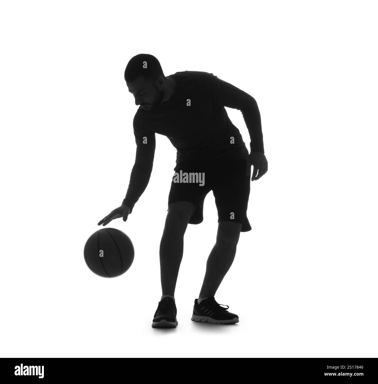 Silhouette of male basketball player on white background Stock Photo