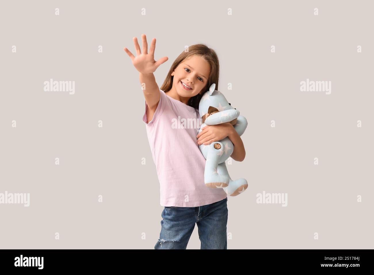 Happy little girl with teddy bear on white background Stock Photo - Alamy