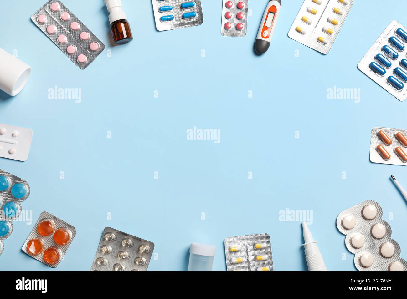Frame made of different medicines and thermometers on color background ...