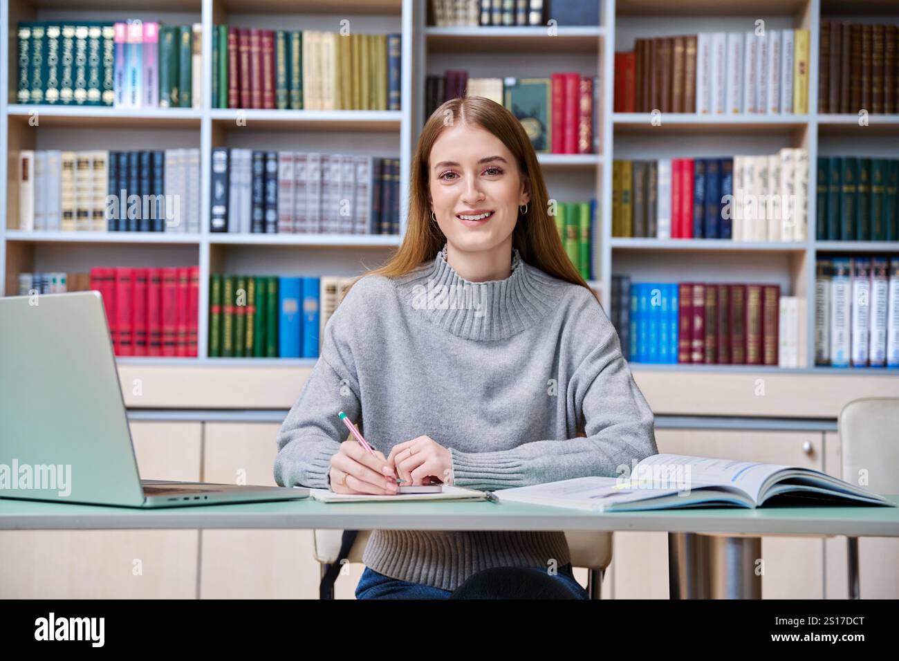 Teenage girl student studying in high school library Stock Photo - Alamy