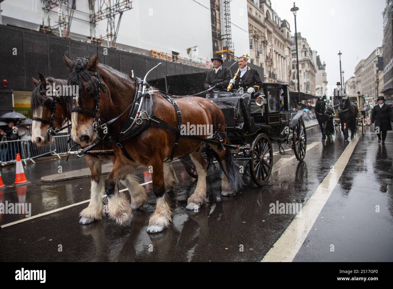 London, UK, 1st January 2025. Two horses pull a cart during a parade