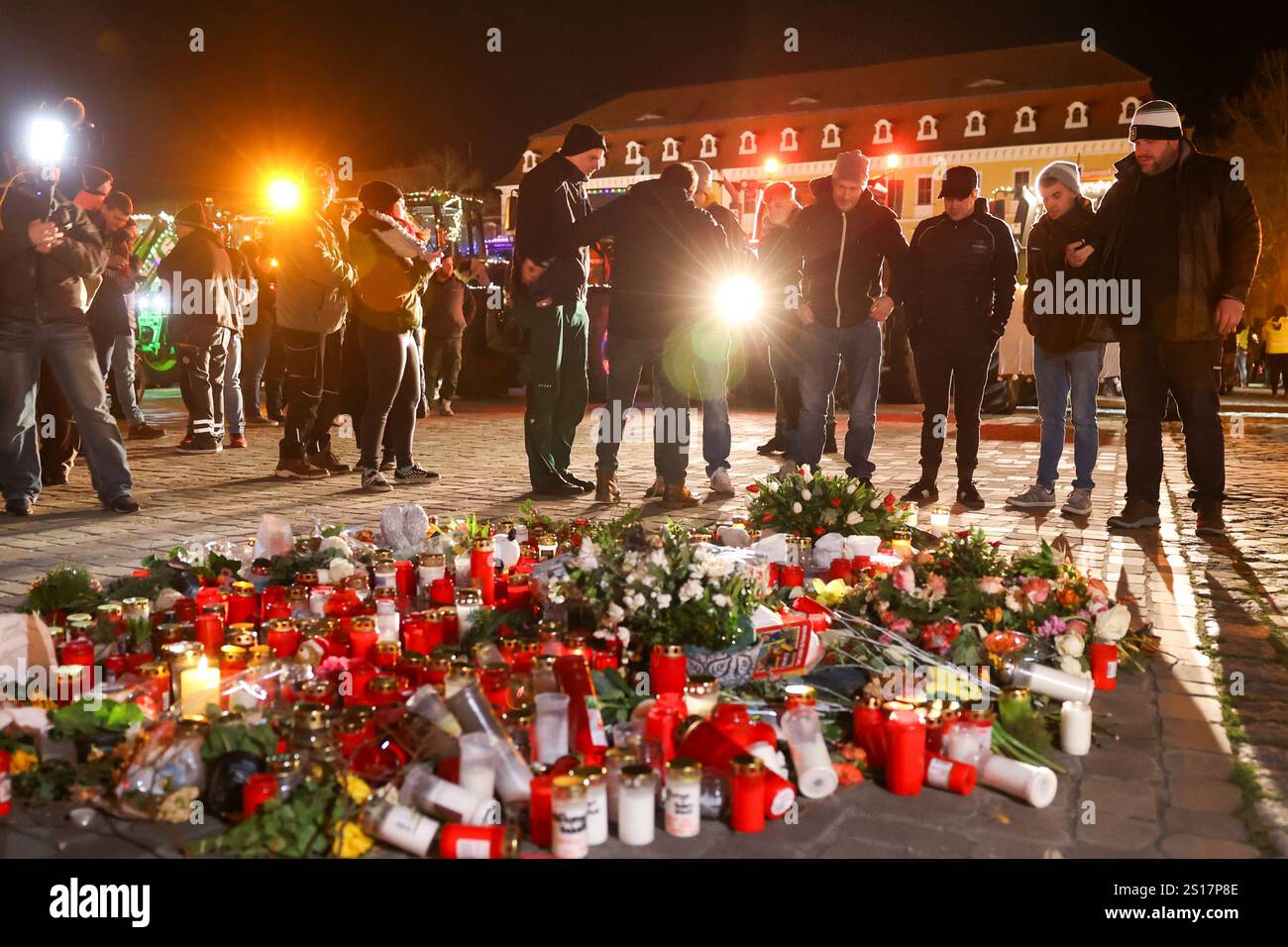 People lay flowers in the cathedral square of Magdeburg, Germany, on