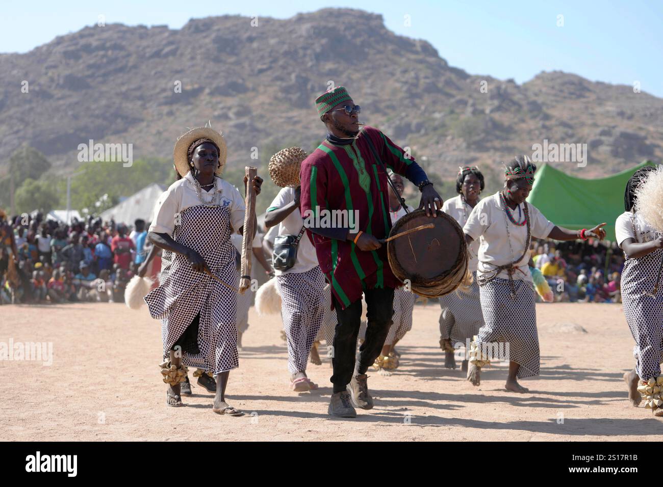 Dancers from the Berom tribe, dressed in traditional clothing, perform