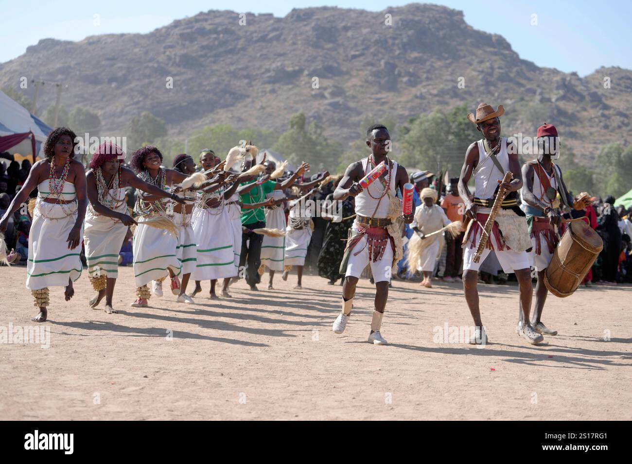 Dancers from the Berom tribe, wearing traditional clothing, perform