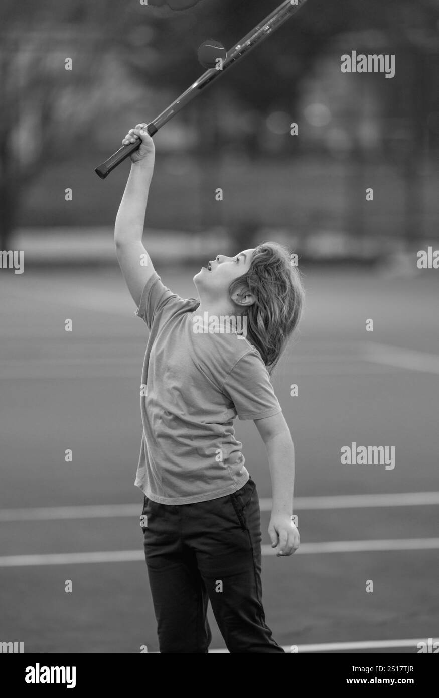 Cute Kid play tennis. Little kid hit tennis ball with tennis racket ...