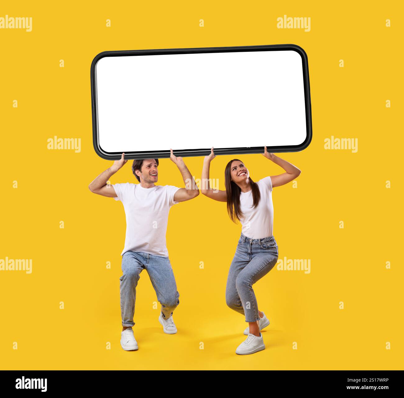 Couple holding heavy white empty smartphone screen Stock Photo