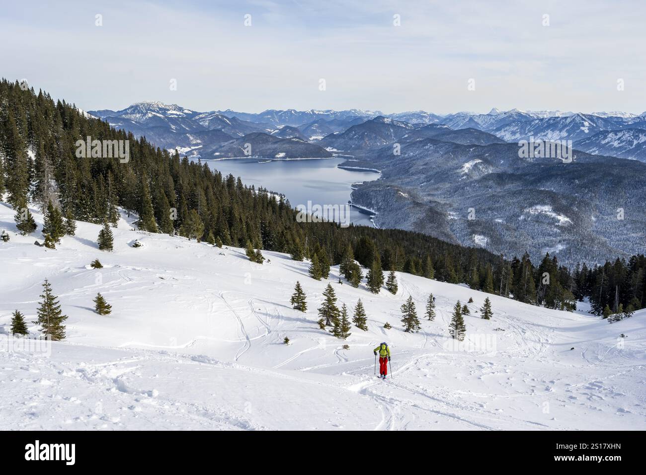 Ski tourers climbing Simetsberg, view of Walchensee, Estergebirge, Bavarian Prealps, Bavaria Germany Stock Photo