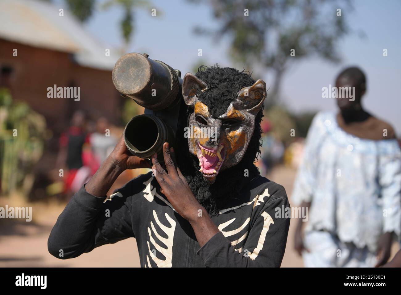 A man wearing a costume attends the Berom annual New Year celebration