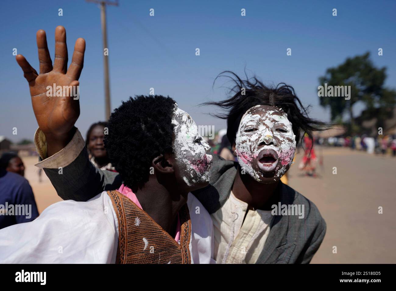 People dressed in costumes perform on the streets during the Berom
