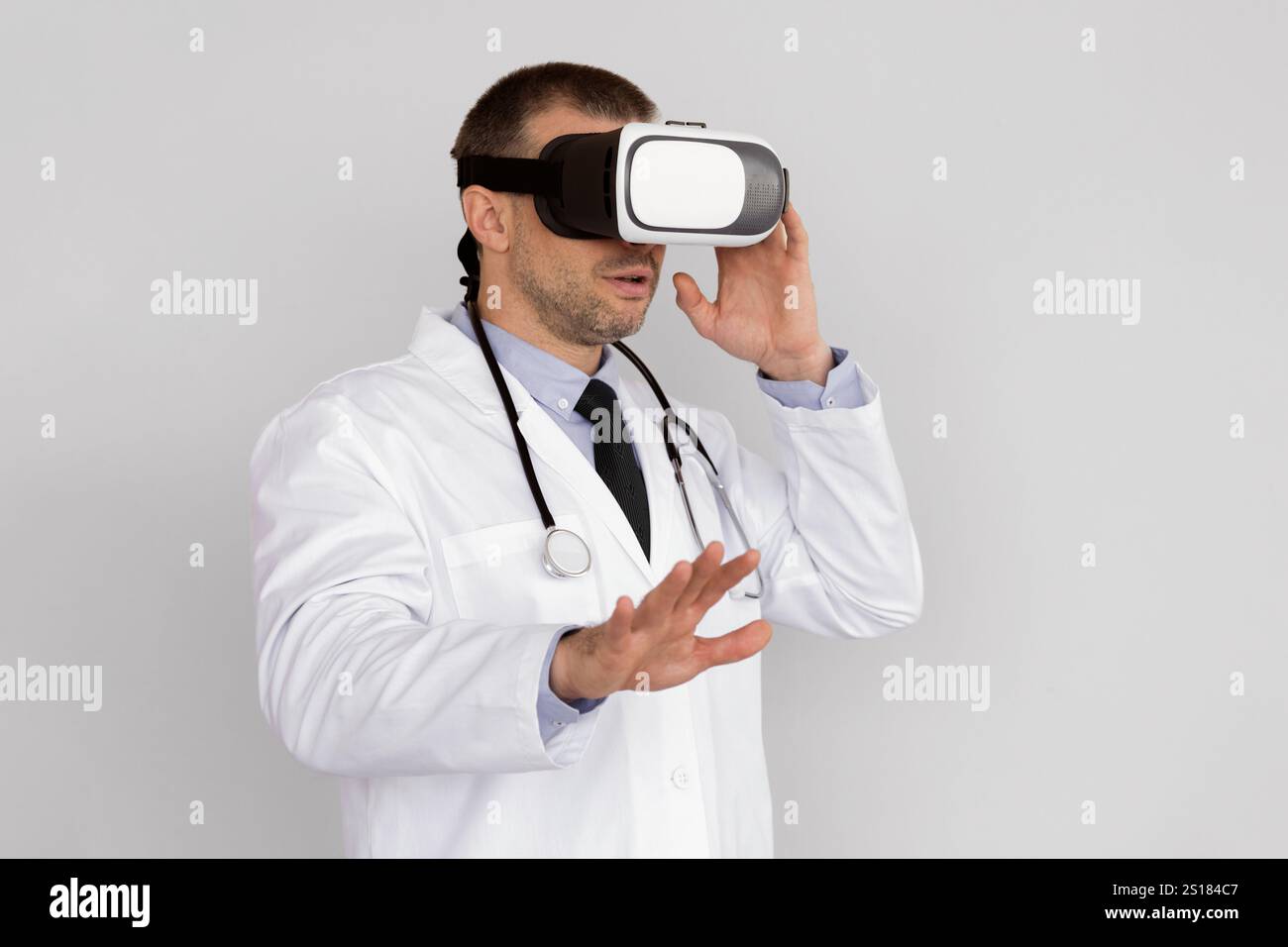 Male Doctor Using Virtual Reality Headset For Medical Purposes Stock Photo