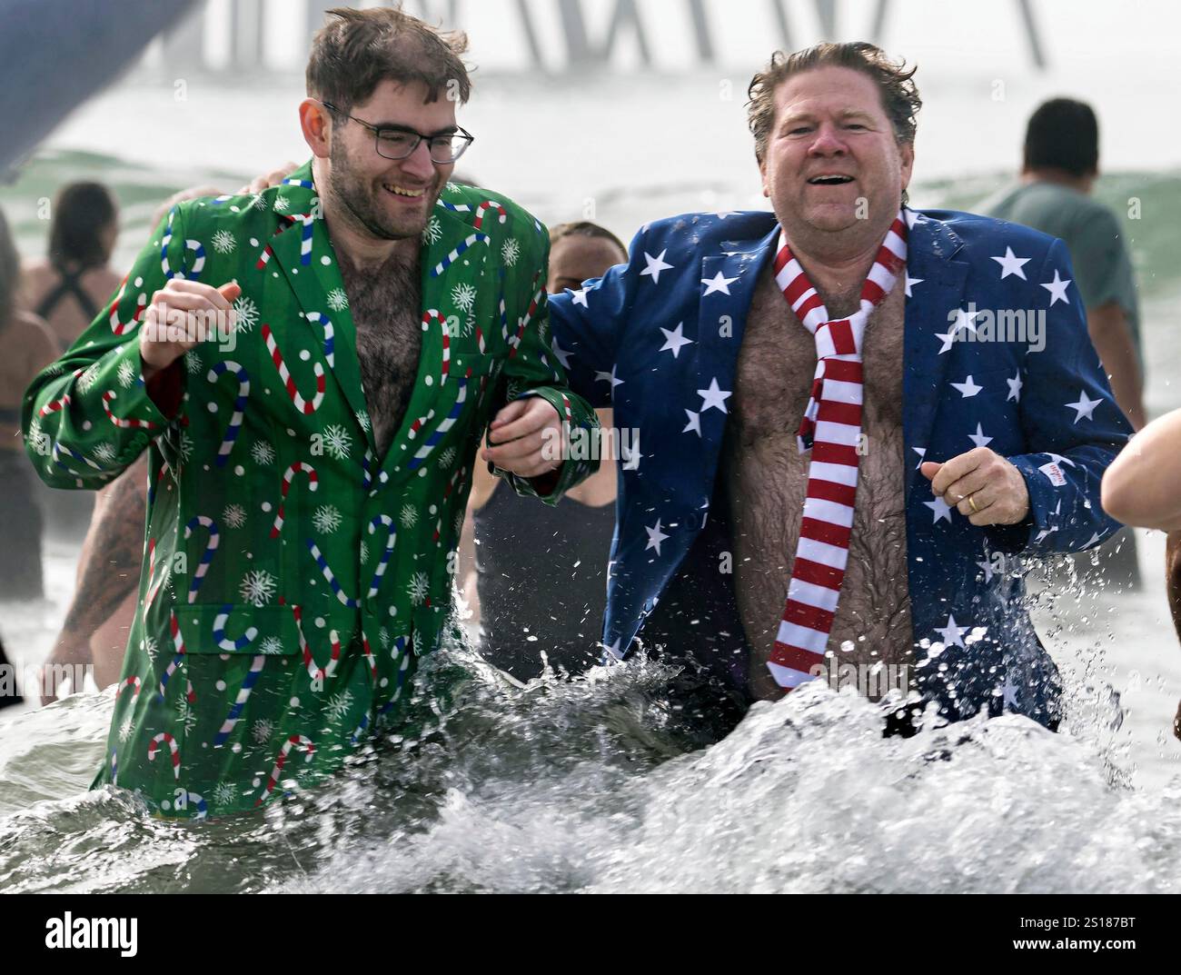People take the plunge into the chilly Pacific during the annual Surf