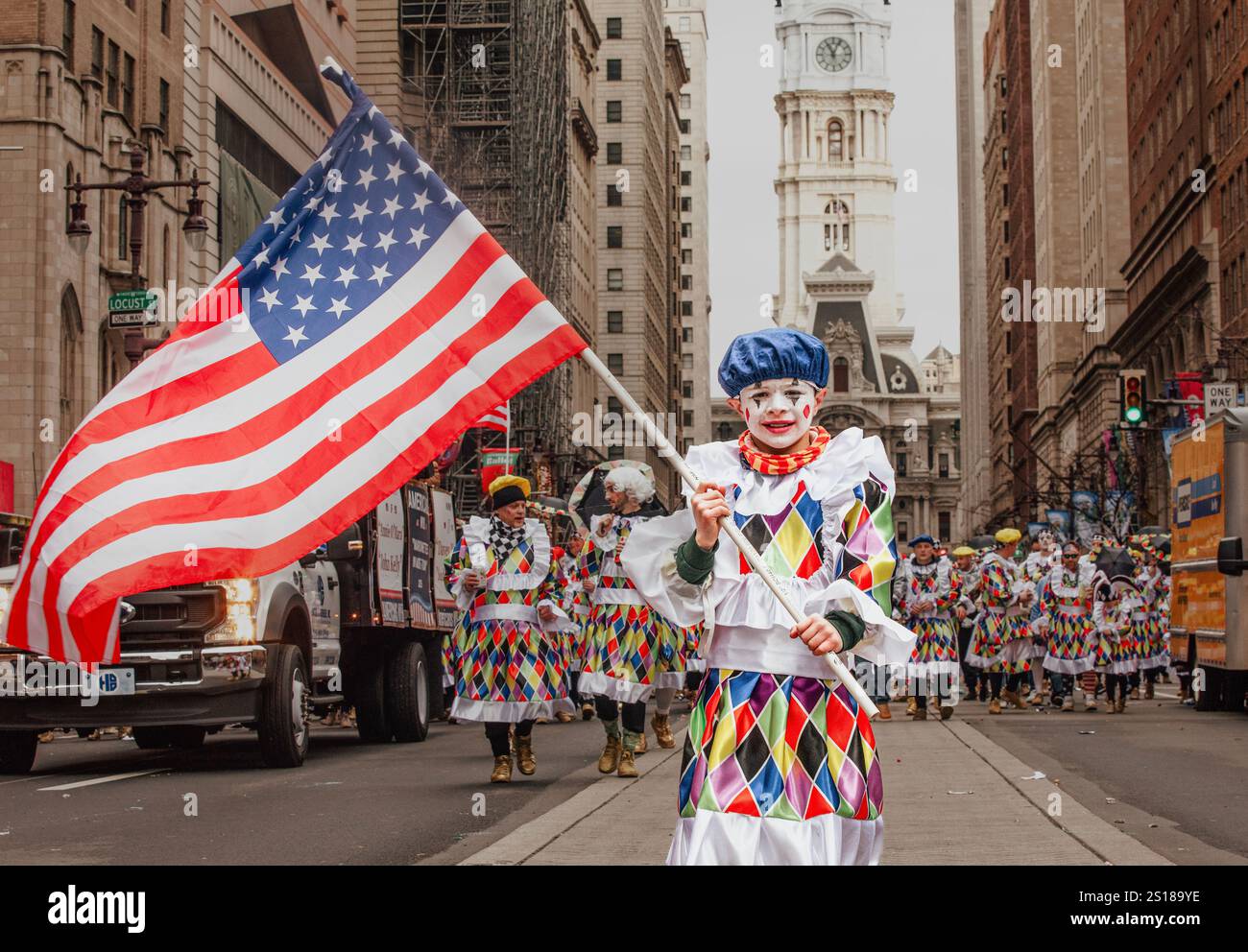 Mummers Parade 2025. A boy in a brightly colored suit with an American